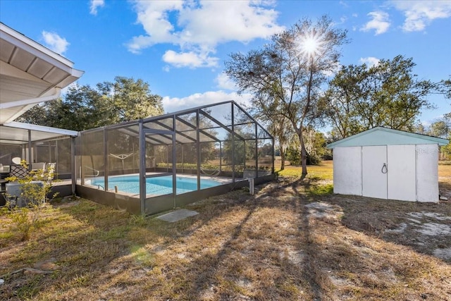 view of swimming pool with a lanai and a shed