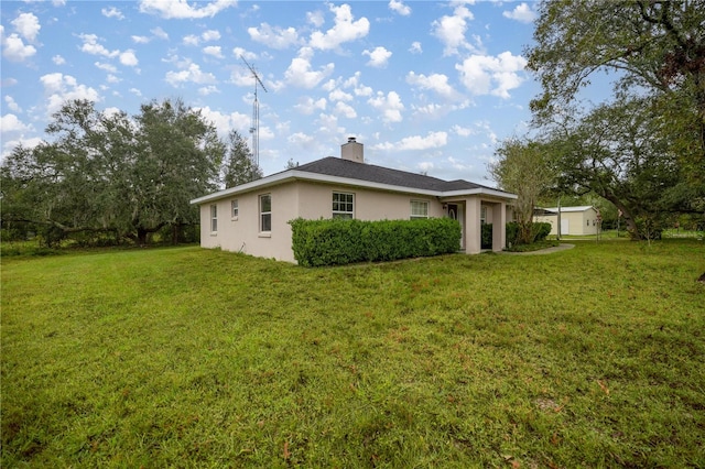 rear view of house with a yard