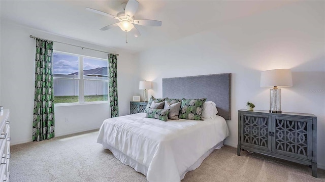 bedroom featuring ceiling fan and light carpet