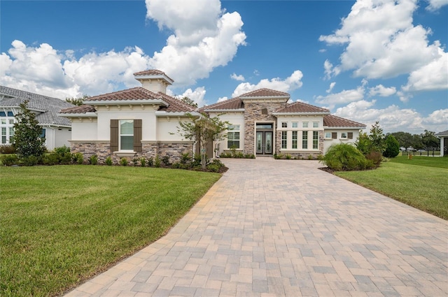 mediterranean / spanish house featuring a front lawn