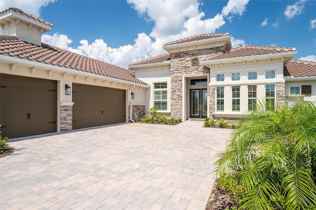 mediterranean / spanish-style house with french doors and a garage