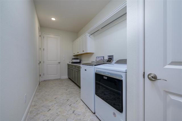 laundry room featuring cabinets and washing machine and clothes dryer