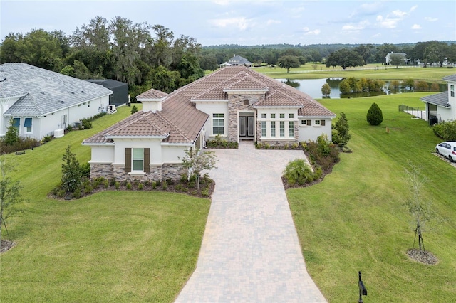 view of front of house featuring a front yard and a water view