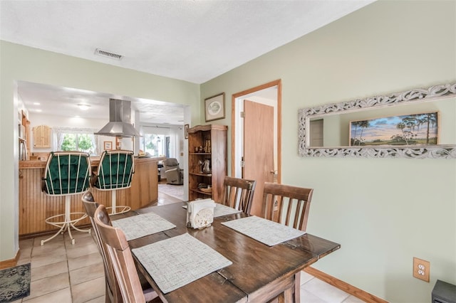 dining area with light tile patterned floors