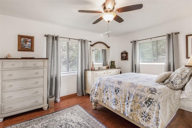 bedroom with multiple windows, ceiling fan, and hardwood / wood-style floors