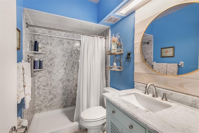 bathroom featuring vanity, curtained shower, and toilet