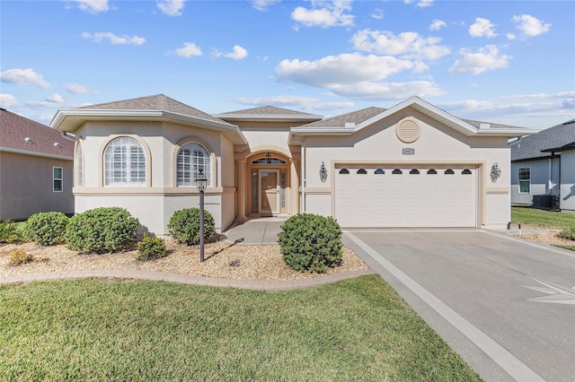 view of front of house with a front yard and a garage