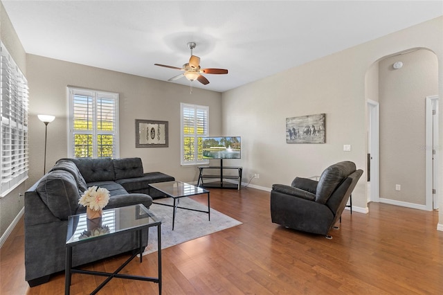 living room featuring wood-type flooring and ceiling fan