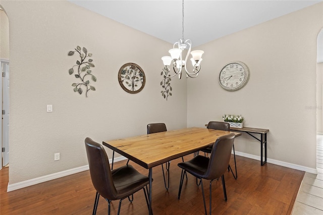 dining area with a notable chandelier and hardwood / wood-style flooring