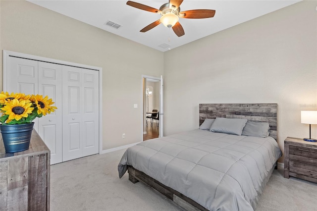 carpeted bedroom featuring ceiling fan and a closet