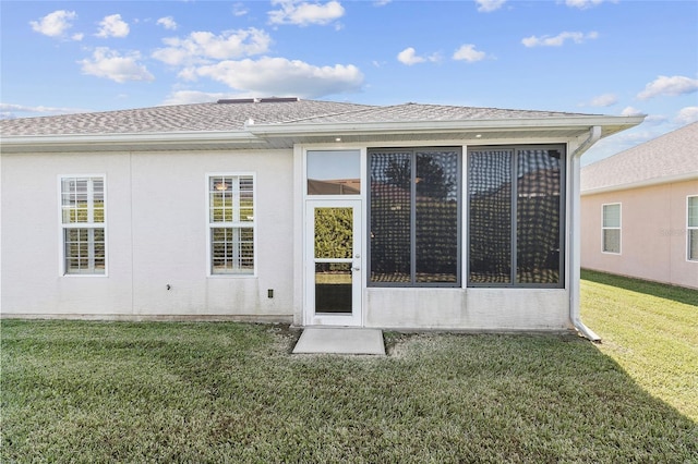 rear view of property with a yard