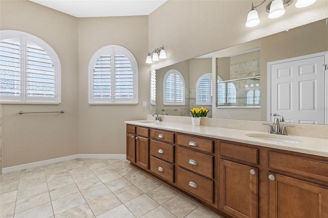 bathroom with a shower, vanity, and tile patterned floors