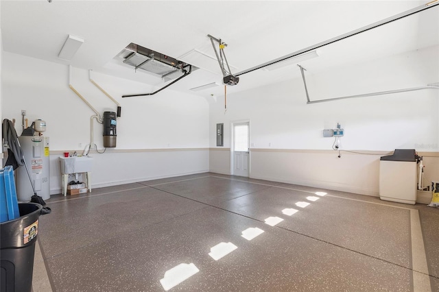 garage featuring water heater, a garage door opener, and electric panel