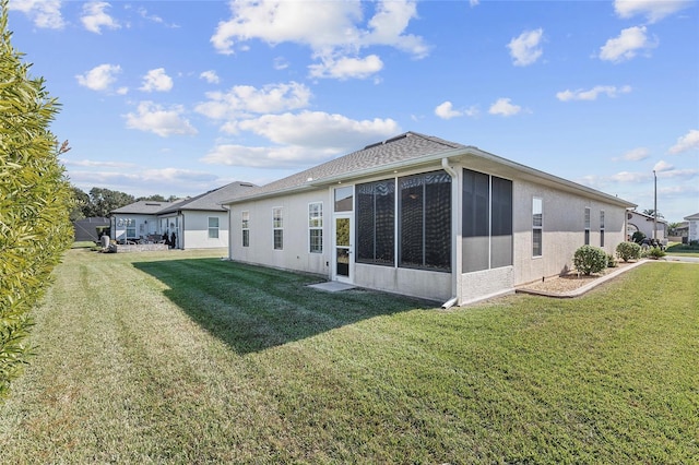 rear view of property featuring a yard