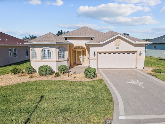 view of front facade featuring a garage and a front lawn