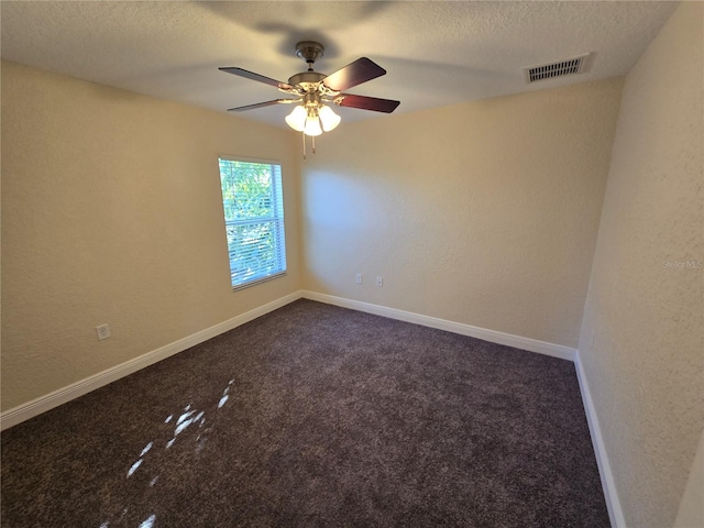 carpeted empty room with a textured ceiling and ceiling fan