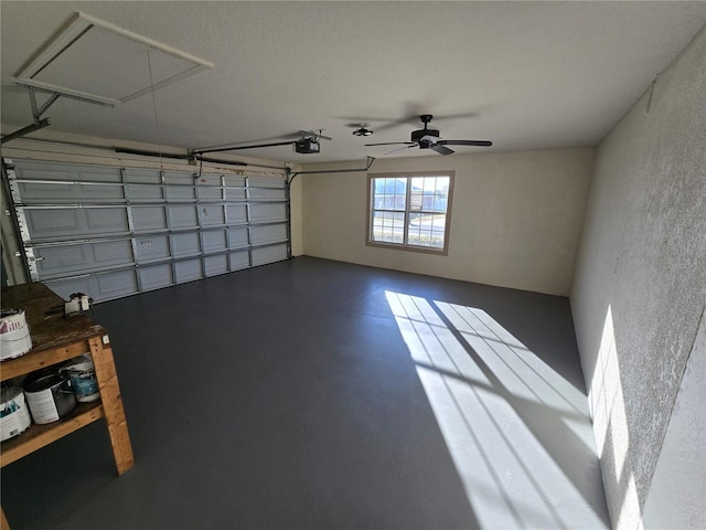 garage with ceiling fan and a garage door opener