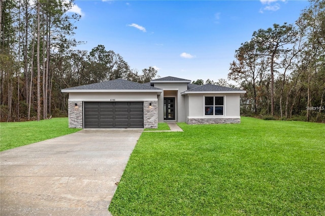 view of front facade with a garage and a front lawn