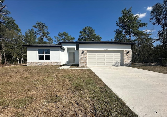 view of front of house featuring an attached garage, stone siding, and stucco siding