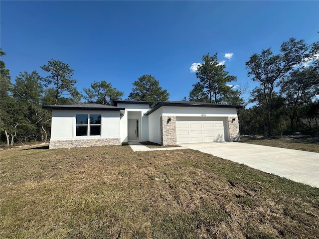 view of front of home with an attached garage, stone siding, driveway, stucco siding, and a front yard