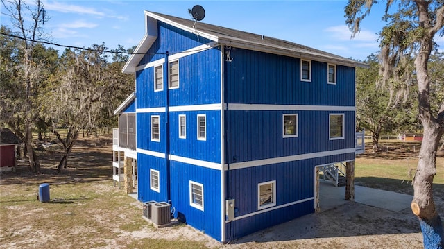 view of side of property featuring central AC