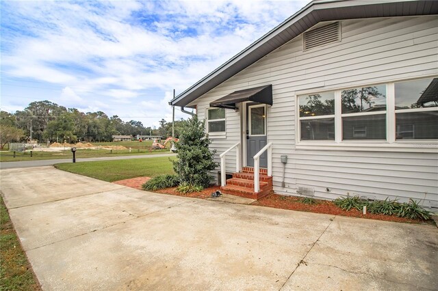 entrance to property with a yard