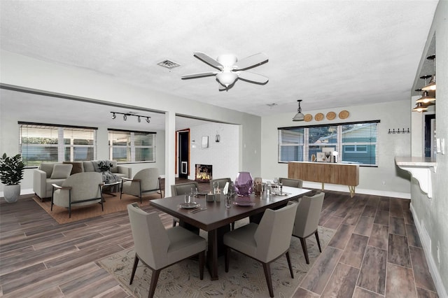 dining space with ceiling fan and a textured ceiling