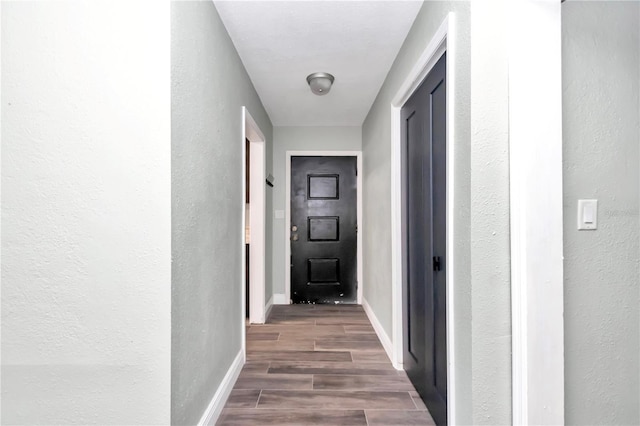 corridor featuring dark hardwood / wood-style floors