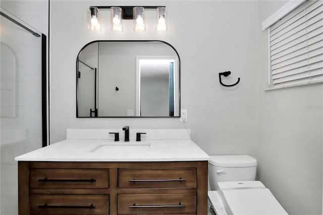 bathroom featuring toilet, vanity, and an enclosed shower