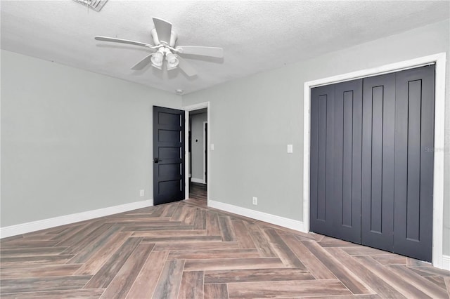 unfurnished bedroom with a closet, ceiling fan, parquet flooring, and a textured ceiling