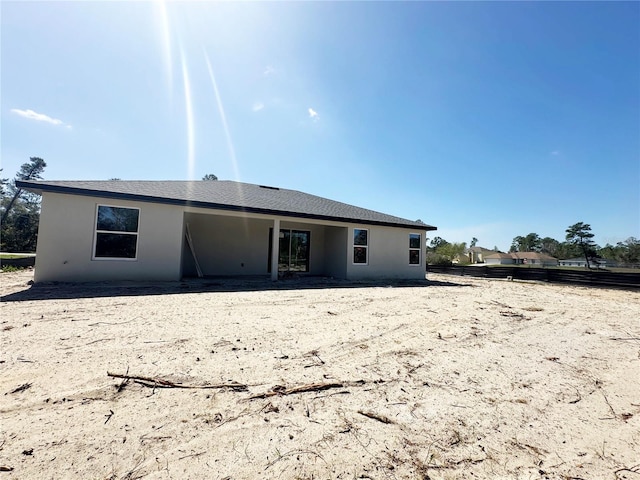 rear view of property with stucco siding