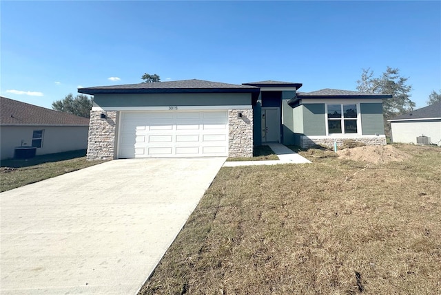 prairie-style house with stone siding, driveway, an attached garage, and stucco siding