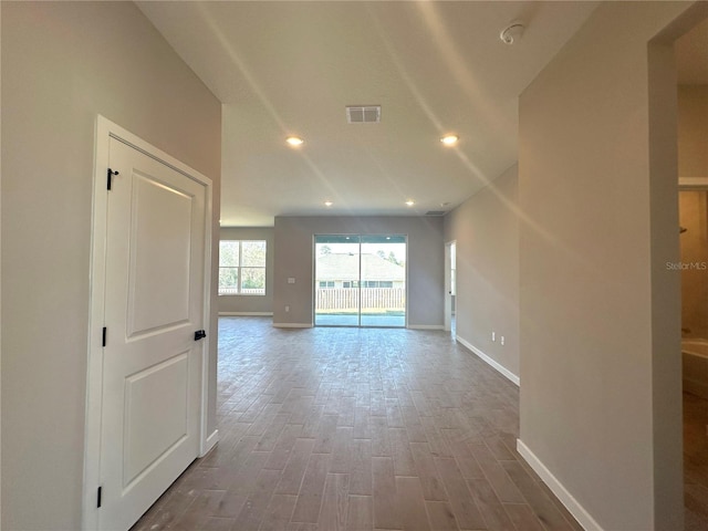 spare room featuring baseboards, visible vents, wood finished floors, and recessed lighting