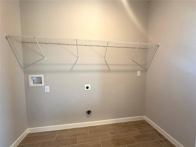 washroom featuring hookup for a washing machine, hookup for an electric dryer, laundry area, baseboards, and wood tiled floor