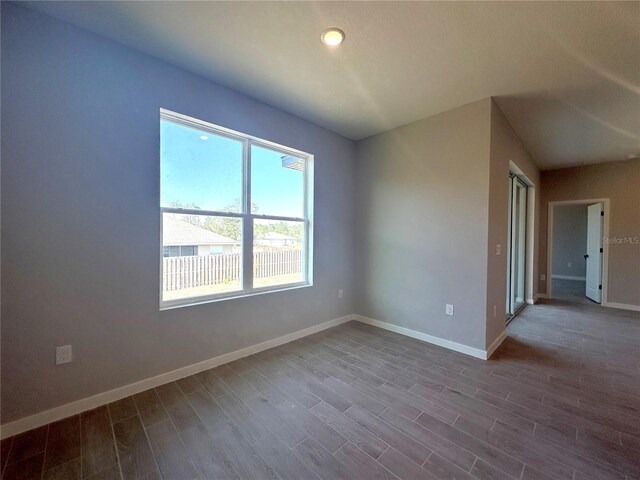 unfurnished room featuring dark wood finished floors and baseboards