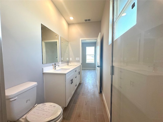 full bath with wood tiled floor, visible vents, a sink, and toilet