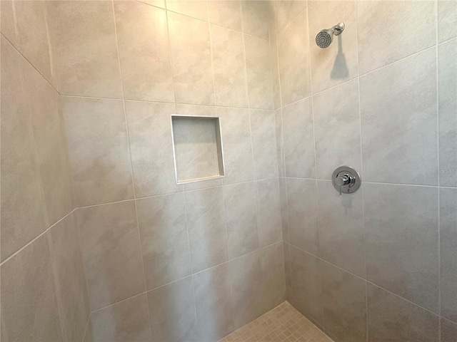 bathroom with tiled shower