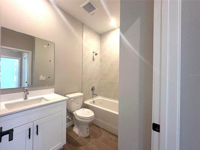 bathroom with toilet, shower / washtub combination, vanity, and visible vents