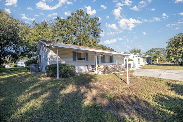 single story home featuring a front yard, central AC, and covered porch