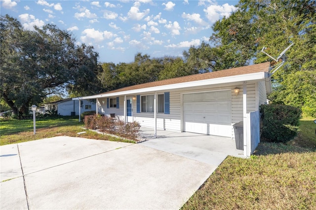 ranch-style home with covered porch, a garage, and a front lawn