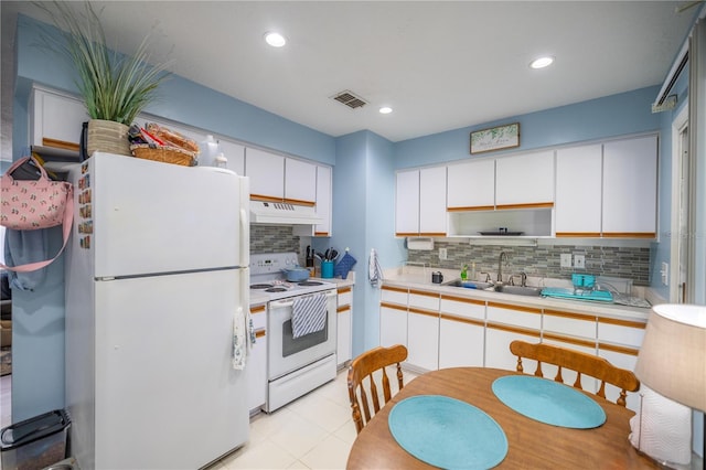 kitchen with white appliances, tasteful backsplash, white cabinetry, and sink