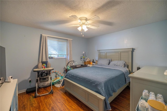 bedroom featuring a textured ceiling, ceiling fan, and dark wood-type flooring