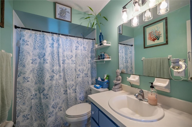 bathroom featuring curtained shower, vanity, and toilet