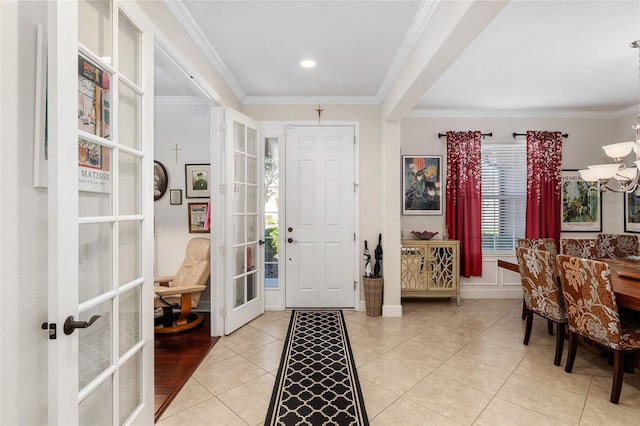 foyer with french doors, light tile patterned flooring, an inviting chandelier, and ornamental molding