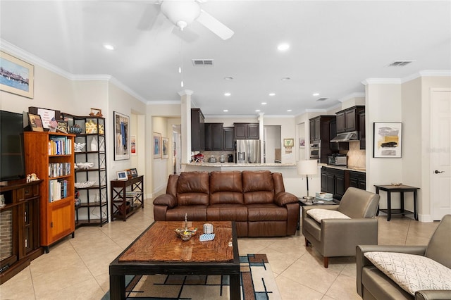 living room with light tile patterned floors, ceiling fan, and ornamental molding