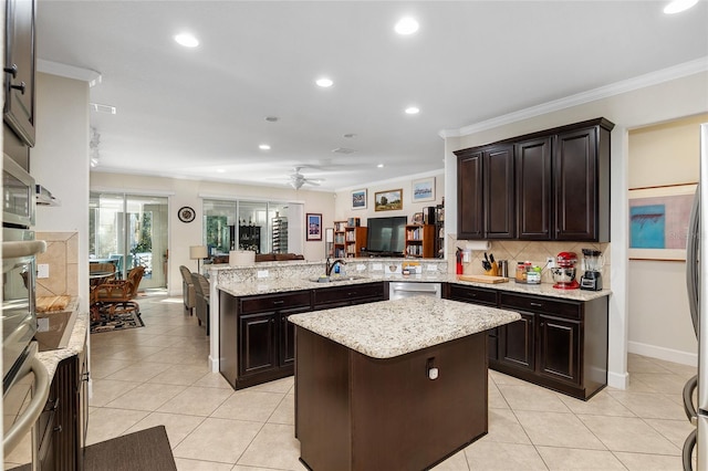 kitchen featuring ceiling fan, a center island, backsplash, kitchen peninsula, and crown molding