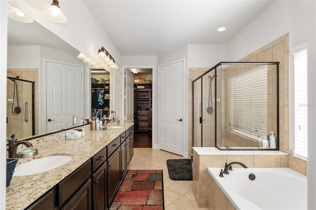 bathroom featuring tile patterned flooring, vanity, and shower with separate bathtub