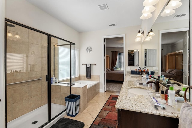 bathroom featuring shower with separate bathtub, vanity, and tile patterned floors