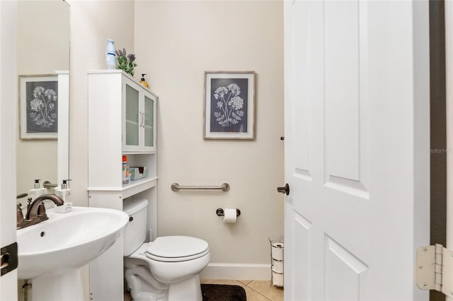 bathroom featuring tile patterned flooring, toilet, and sink