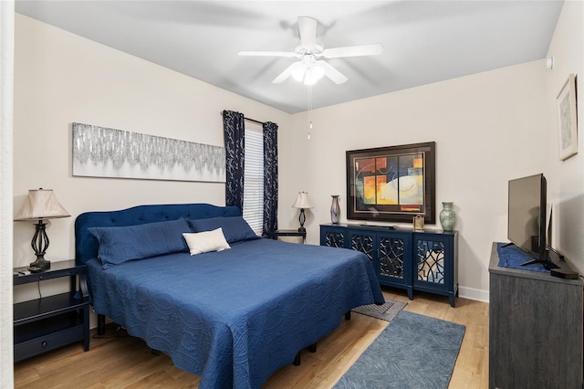 bedroom with ceiling fan and light hardwood / wood-style floors